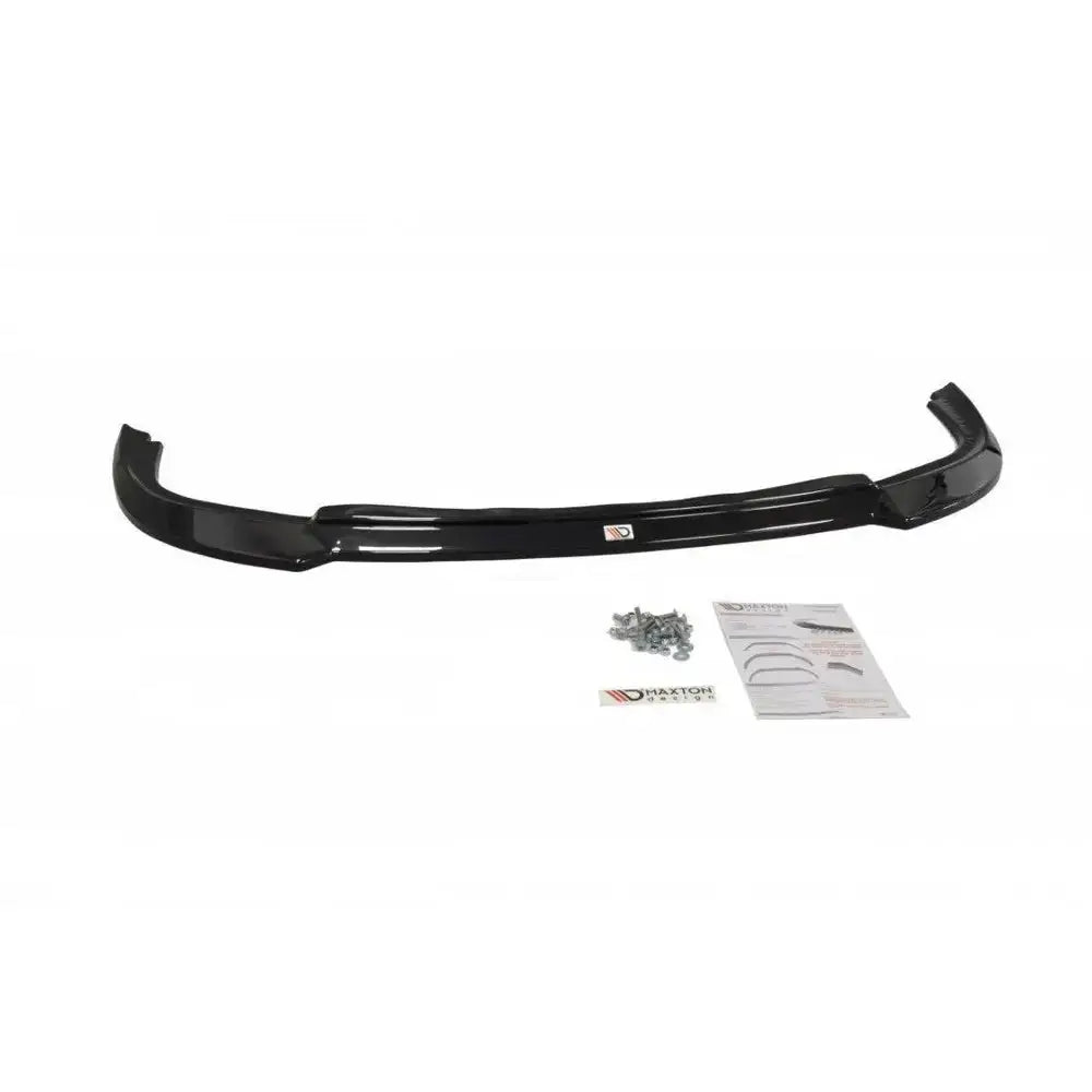 Frontspoiler Subaru Impreza II WRX V.1 i sort plast med monteringsskruer og instruksjonsark ved siden av.