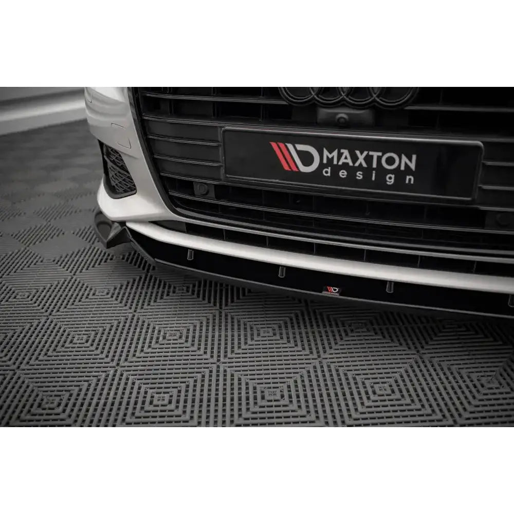 Front splitter på Audi A6 C8 V.2 med svart Maxton Design-logo, hvit støtfanger og grått gulv.