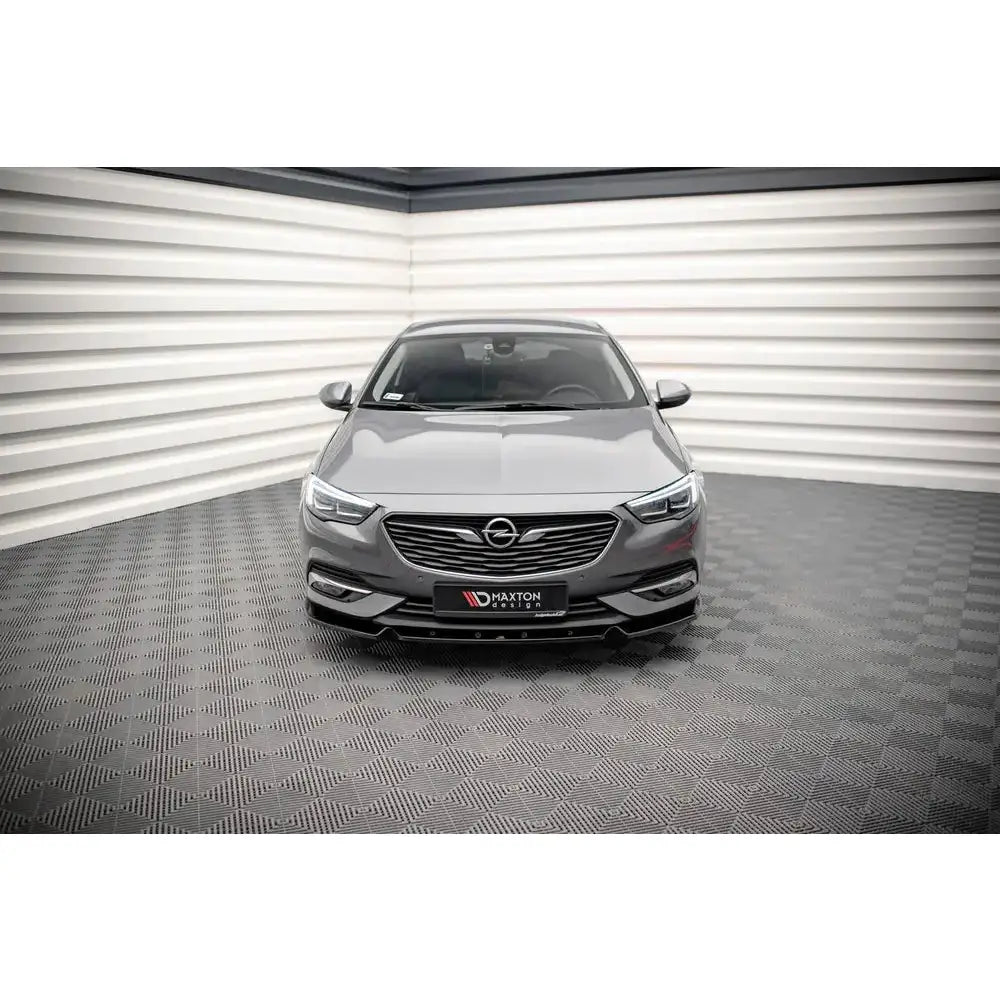 Frontleppe på Opel Insignia Mk2 17- sett forfra i showroom med markante frontlykter og svart grill.