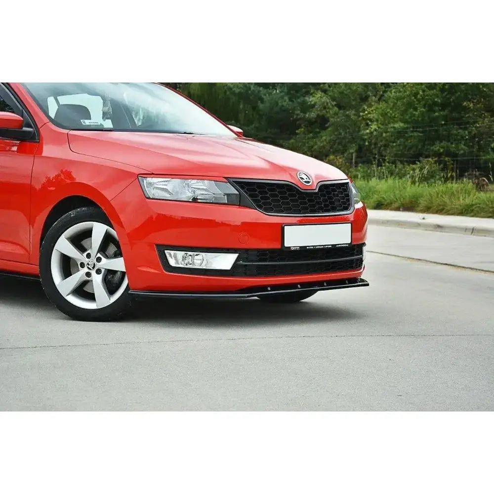 Frontleppe på rød Skoda Rapid V.2 med sort frontsplitter og fem-eikers felger parkert på asfalt.