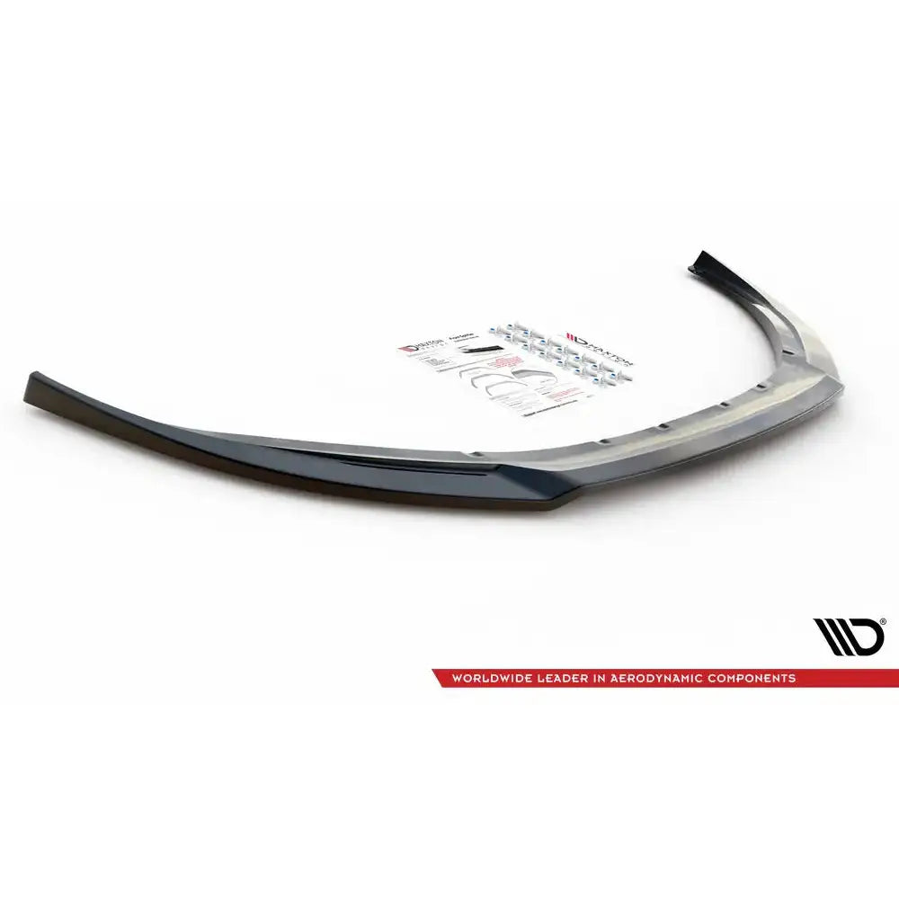 Front lip til Volvo V70 Mk3 V.2 07-13, sort plast med monteringsutstyr og instruksjoner i bakgrunnen.