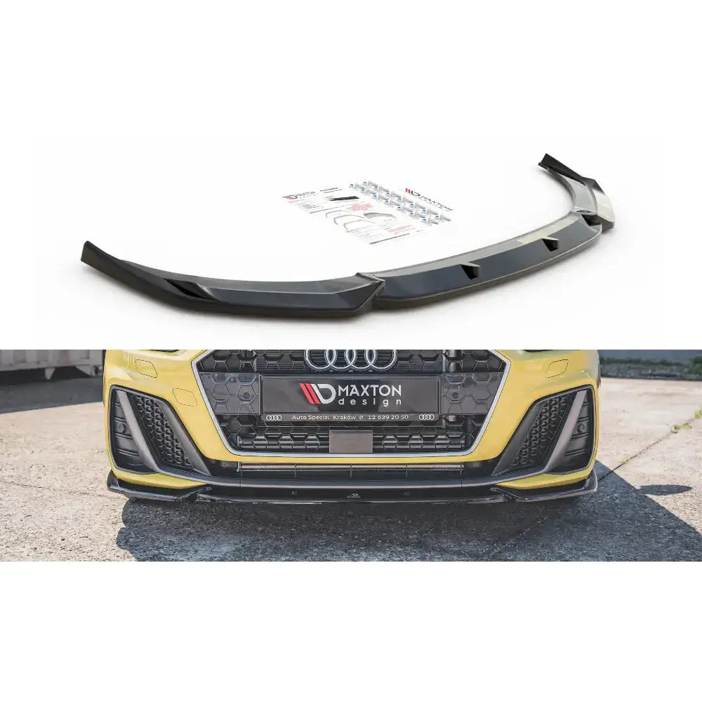 Frontspoiler Audi A1 S-Line GB V.3 i sort plast med monteringsutstyr, vist på gul bil forfra.
