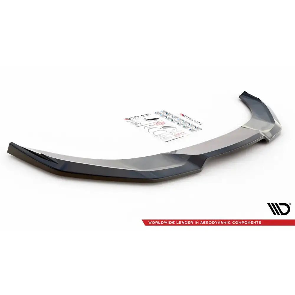 Front lip til Nissan 370Z Nismo Facelift, sort glanset splitter med utstyr og instruksjoner i bakgrunnen.