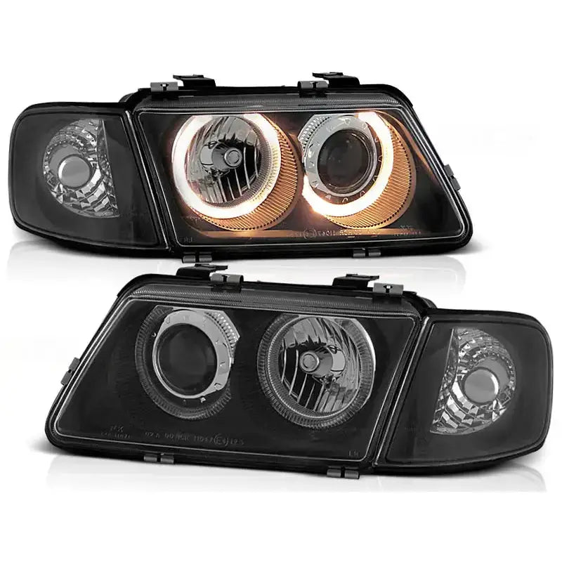 Frontlykter Audi A3 Angel Eyes Black med runde LED-lys og kromdetaljer, sett forfra.