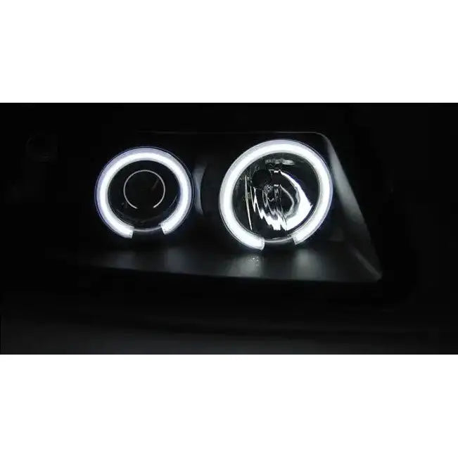 Headlights Audi A3 8L Angel Eyes CCFL Black med hvite LED-ringer, avbildet i mørket.
