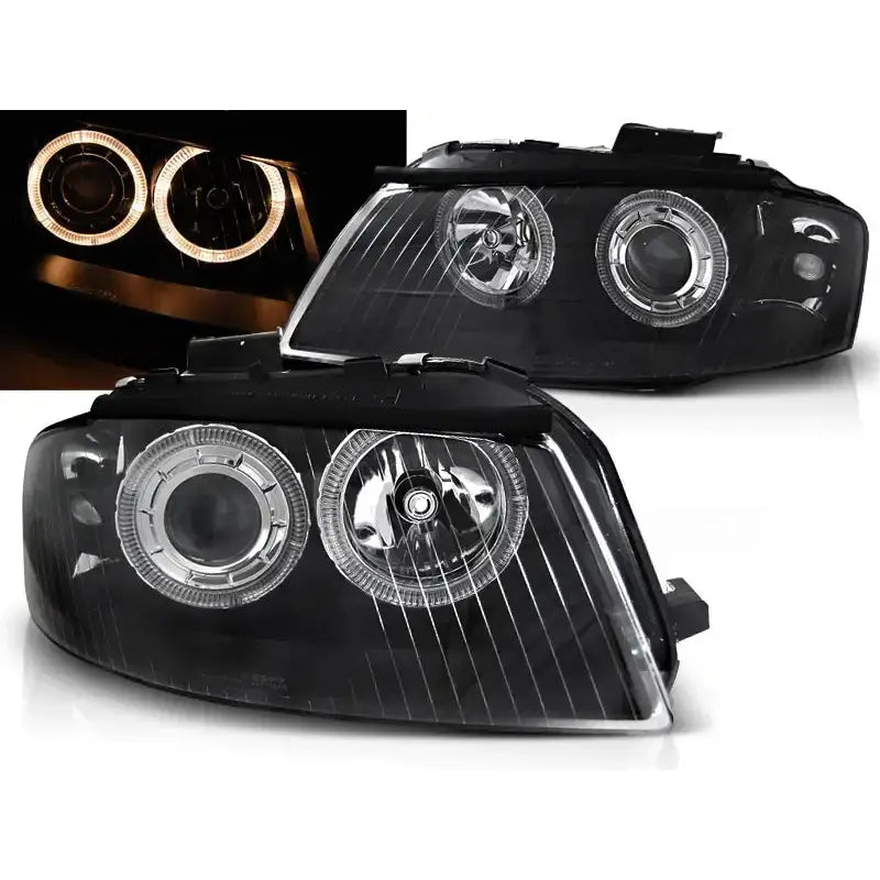 Frontlykter Audi A3 8P Angel Eyes Black med sorte detaljer og opplyste LED-ringer, sett fra skrå vinkel.