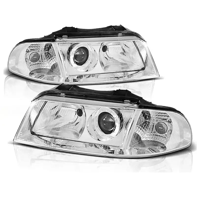 Frontlykter Audi A4 01.99-11.00 Chrome med sorte detaljer og runde linse-elementer, sett forfra.