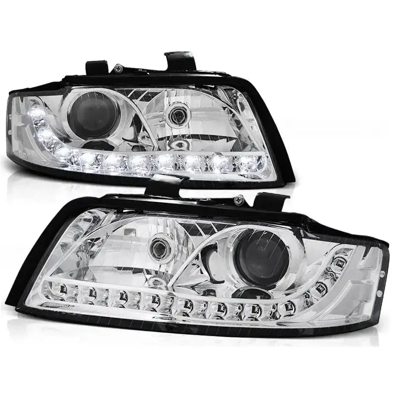 Frontlykter Audi A4 10.00-10.04 Chrome med svart kant, LED-lys og runde linser, sett forfra.