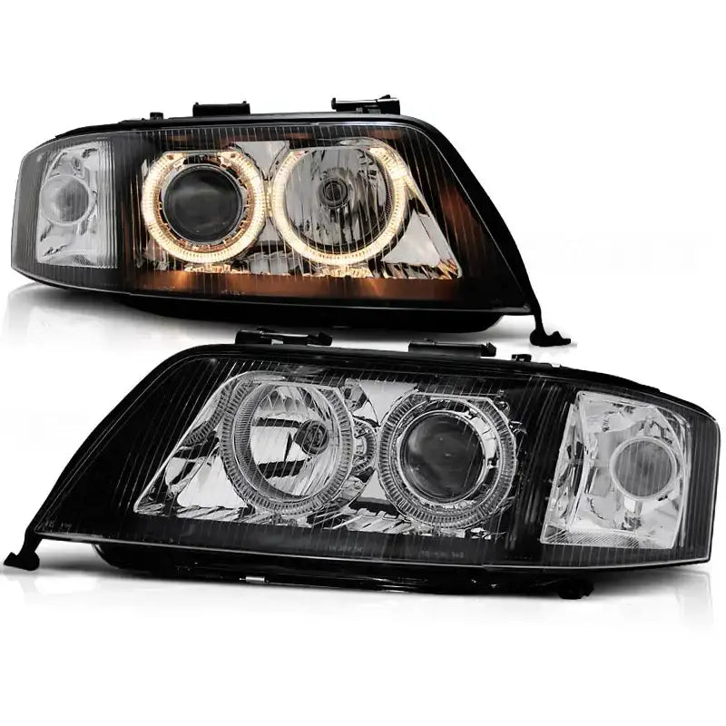 Frontlykter Audi A6 Angel Eyes Black med LED-ringer og sorte detaljer, vist fra skrå vinkel.