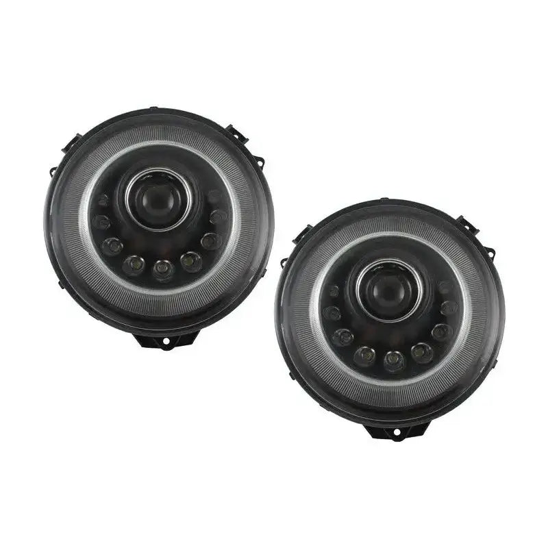 Frontlykter Bi-Xenon Dynamic Mercedes G-Klasse W463, to runde lykter med sort ramme og klar linse.