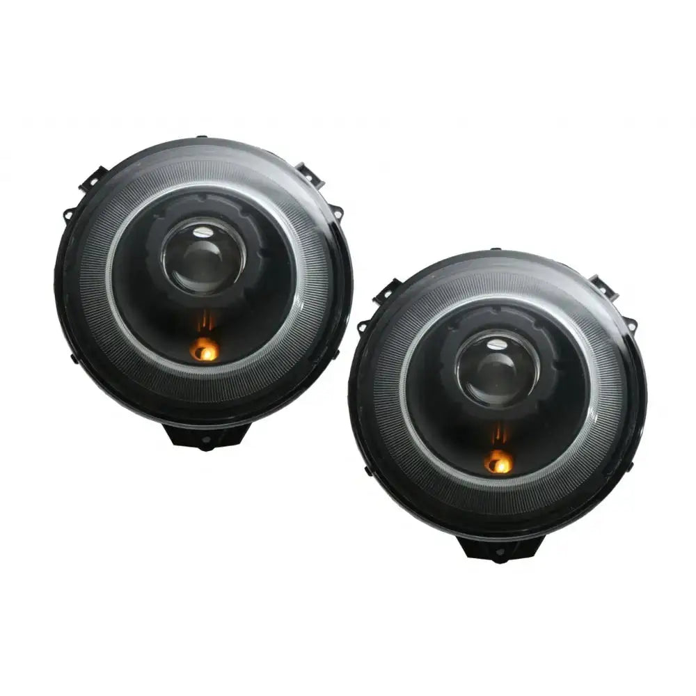 Hovedlys Bi-Xenon Mercedes G-Klasse W463, sorte runde frontlykter med oransje detalj nederst.