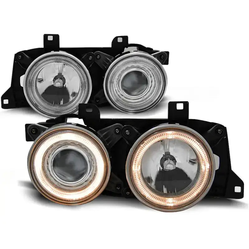 Hovedlykter Bmw E32/E34 Chrome med klart glass og svart ramme, nederste sett med tente lysringer.