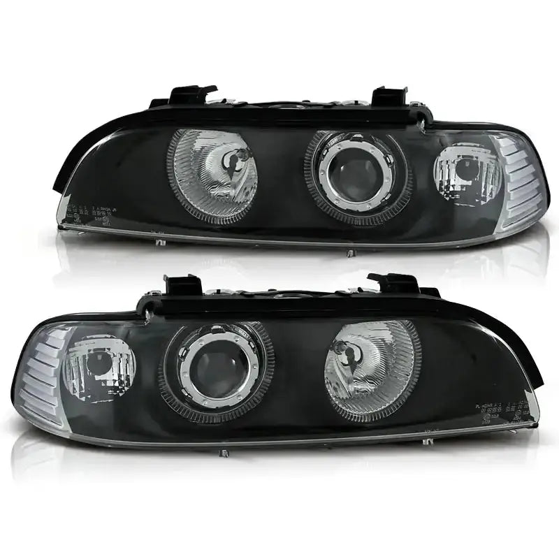Hovedlykter Bmw E39 Angel Eyes Black med sølvinnsatser og runde reflektorer sett forfra.