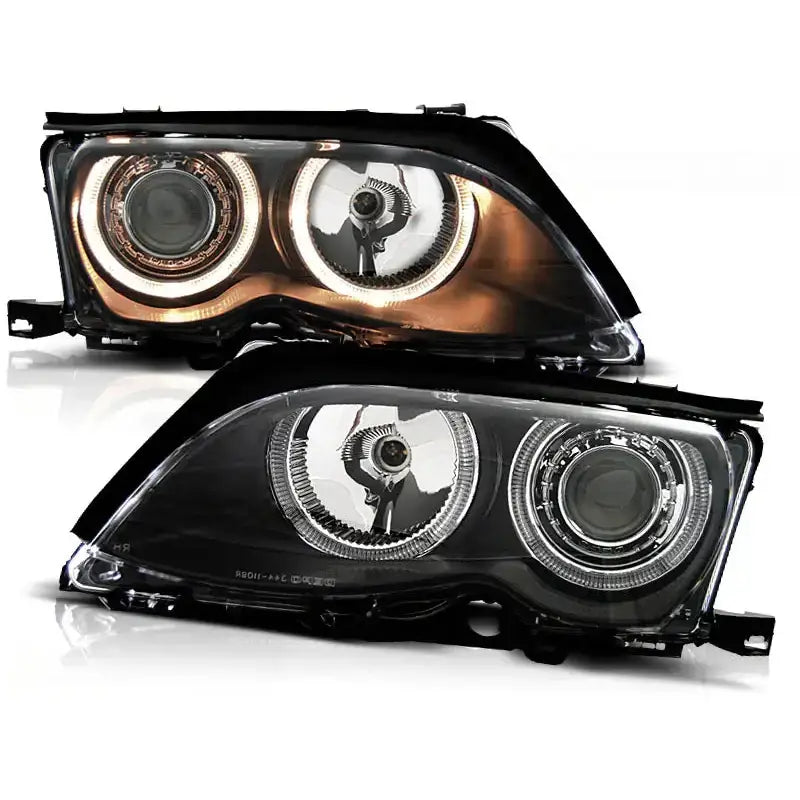 Frontlykter Bmw E46 Angel Eyes Black med sort ramme og LED-ring, sett forfra på hvit bakgrunn.
