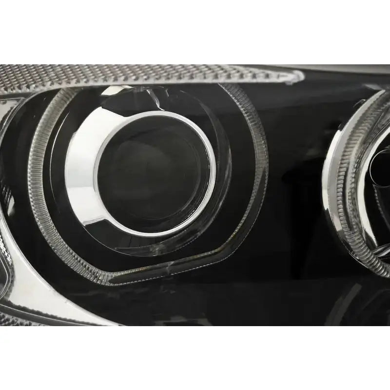 Hovedlykter Bmw E90/E91 med LED Angel Eyes, nærbilde av sort og sølv reflektor med klare linser.