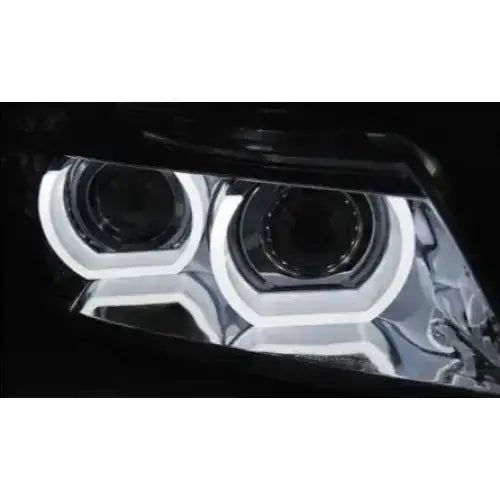 Hovedlys BMW E90/E91 Xenon LED DRL med to runde lysringer og kromdetaljer mot mørk bakgrunn.
