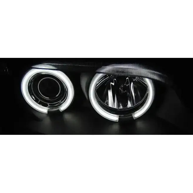 Hovedlys Bmw Z3 Angel Eyes CCFL Black sett forfra med hvite LED-ringer i mørkt miljø.