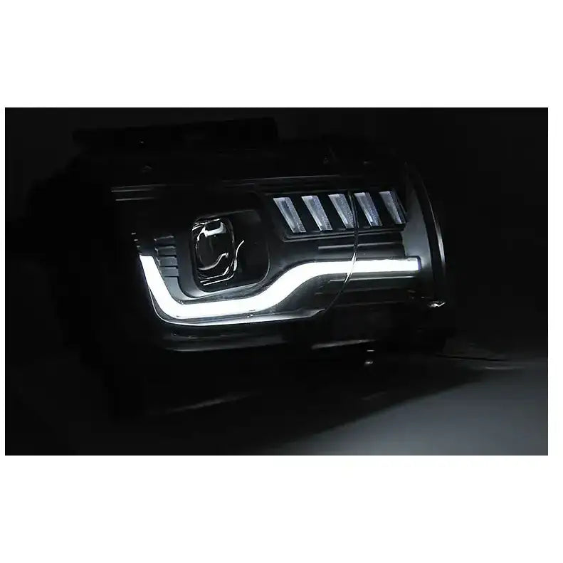 Hovedlys Chevrolet Camaro 09-13 Tube Light Black med LED-lysstripe, fotografert forfra i mørket.