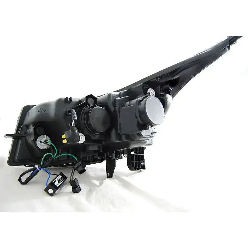 Hovedlys Chevrolet Cruze 09-12 Tube Light Black sett bakfra med synlige ledninger og elektriske kontakter.
