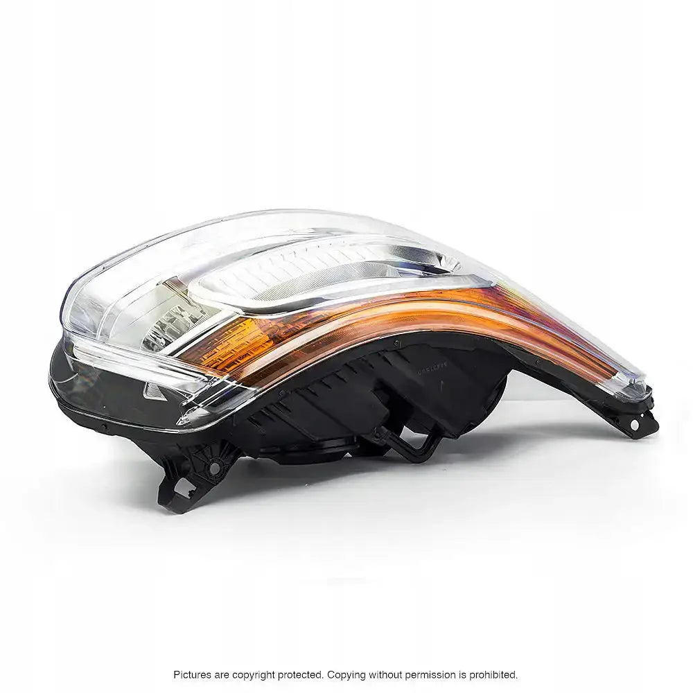 Frontlykter Citroen C3 Picasso med klar plastdeksel, svart bakside og oransje reflektor fra siden.