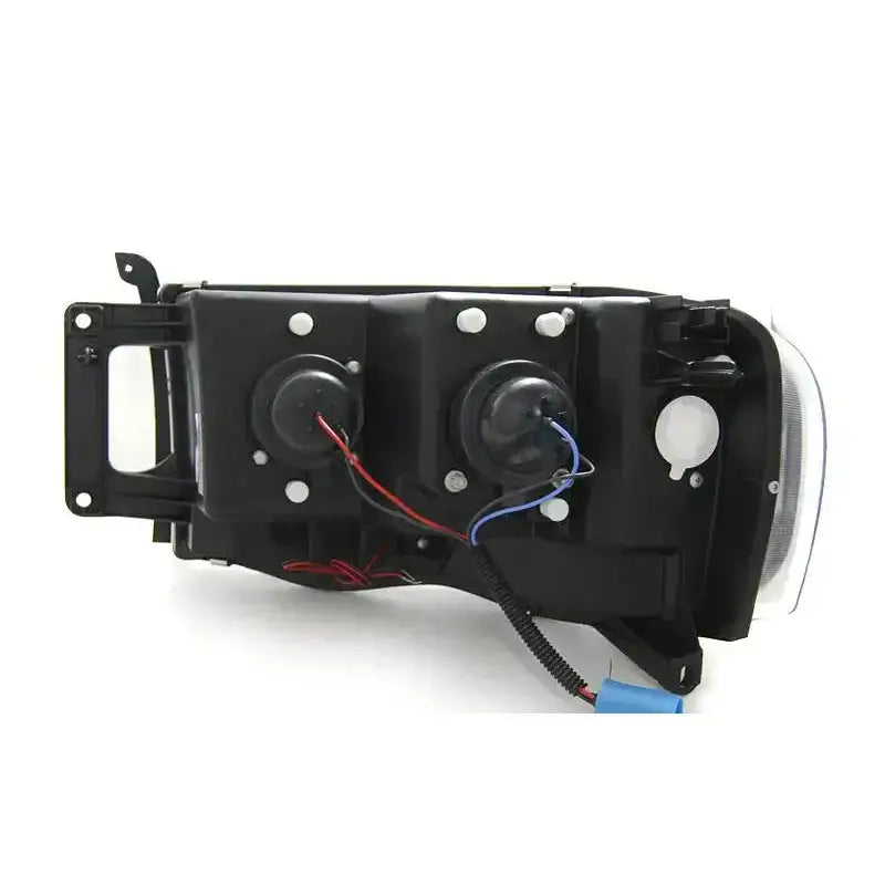 Headlamp bakside av Dodge Ram 02-06 Tube Light Black med synlige koblingspunkter og ledninger.