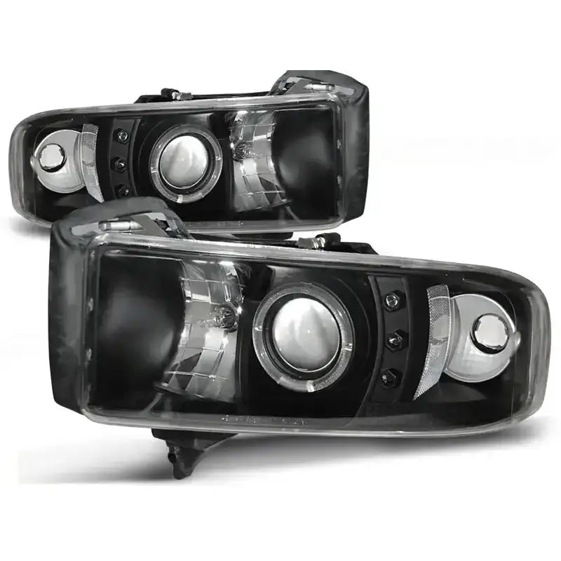 Hovedlykter Dodge Ram 94-01 Angel Eyes Black med svarte hus, klare linser og rund projektorlinse.