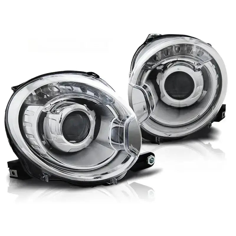 Frontlykter Fiat 500 07 projektor chrome, to runde billykter i klart glass og sølv, sett forfra.