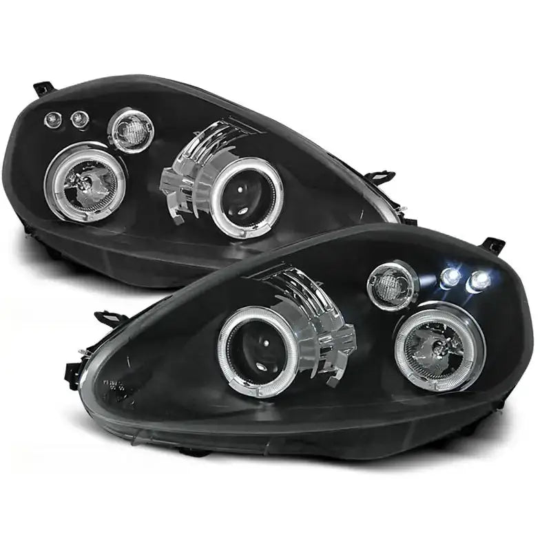 Hovedlykter Fiat Grande Punto Angel Eyes Black vises skrått forfra med runde linser og kromdetaljer.