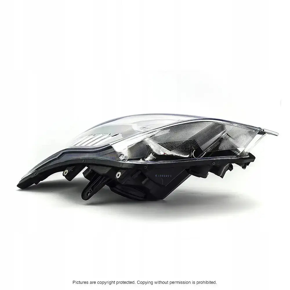 Hovedlys Ford Kuga 08-12 H7/H7 sett fra siden med klar plast og synlig reflektor.