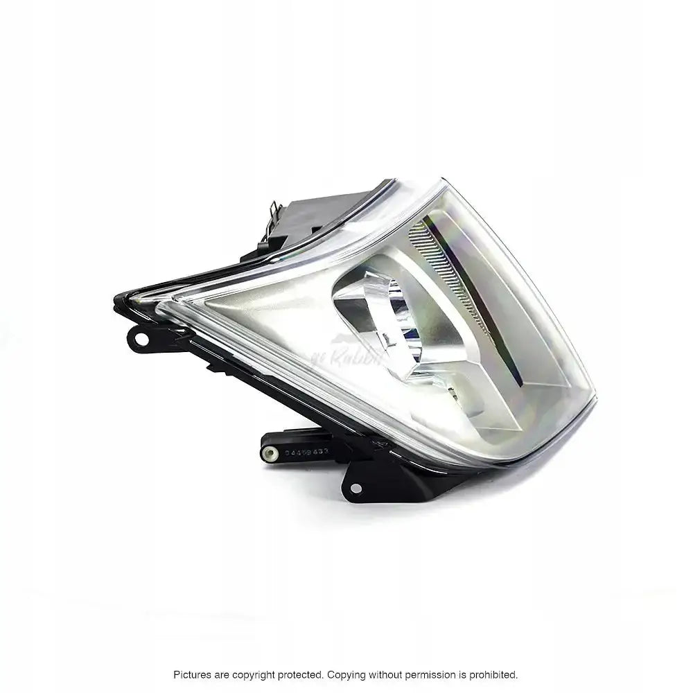 Headlights Ford Transit 06-13 H4 sett skrått forfra, klar plast og sort metall, reflektor synlig.