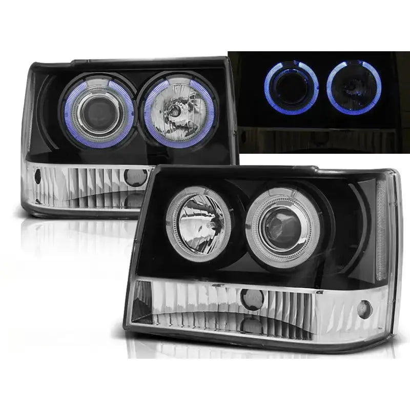 Frontlykter Grand Cherokee 93-98 BlackS med klart glass og svarte detaljer, LED-lysring i blått.