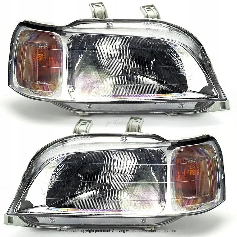 Frontlykter Honda Civic 6 97-01 H4 med klart glass og oransje blinklys, sett fra skrå forsidevinkel.