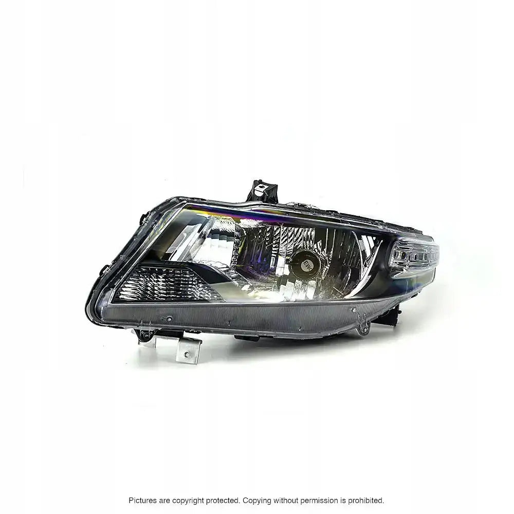 Hovedlykter Honda CR-Z 10-13 sett fra skrå vinkel med synlige reflektorer og pære gjennom klar plast.