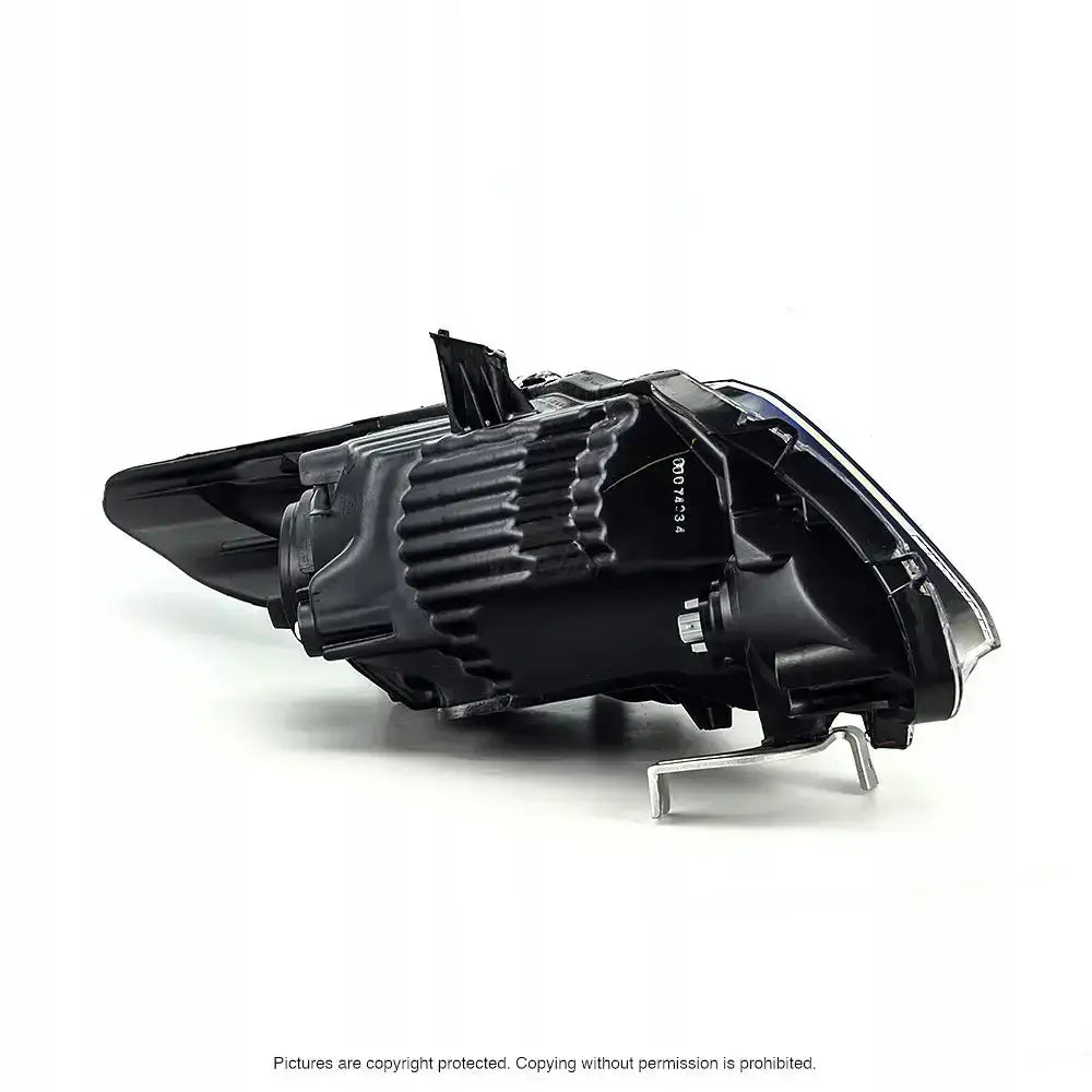 Hovedlys Honda CR-Z 10-13 vist fra siden med svart plast, ribbet overflate og metallfeste mot hvit bakgrunn.