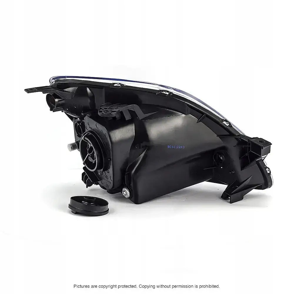 Headlamp Honda CRV 01-04 vist bakfra med festepunkter og rund lokk på svart plastkomponent.