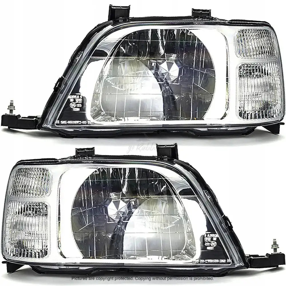 Frontlykter Honda CRV I 95-02 med klart glass, sølvreflektor og svarte detaljer, sett fra skrå frontvinkel.