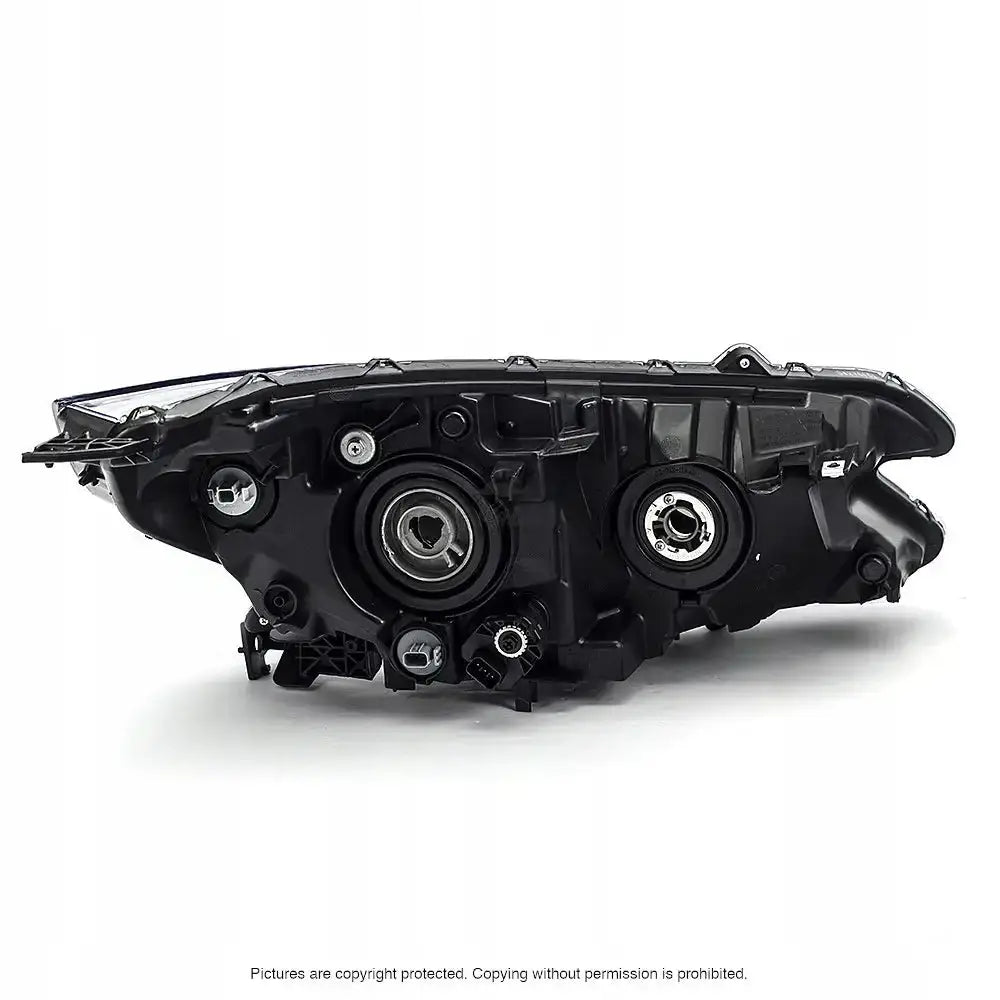 Headlamp bakside av Honda CRV IV 14- frontlykt med monteringspunkter og åpninger, mot hvit bakgrunn.