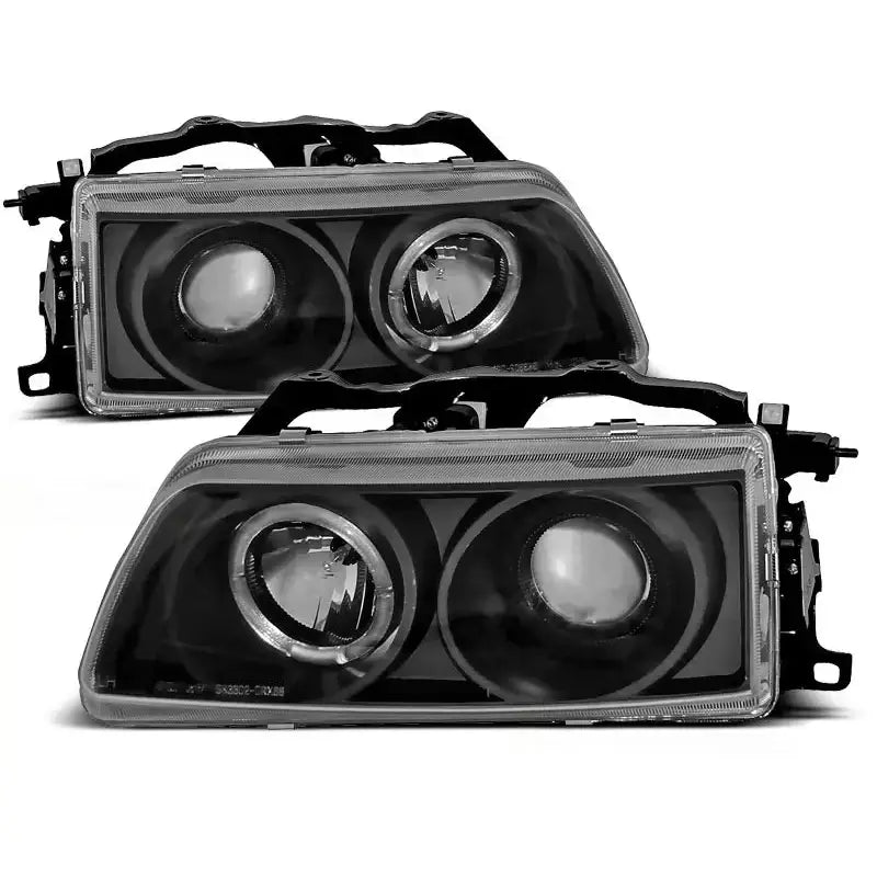 Hovedlykter Honda CRX Angel Eyes Black med to runde linser i svart innfatning, sett forfra skrått.