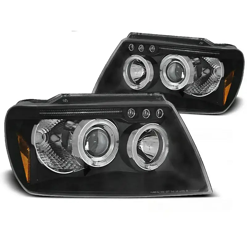 Frontlykter Jeep Grand Cherokee 99-05 Angel Eyes Black med sorte hus og oransje refleksdetaljer.