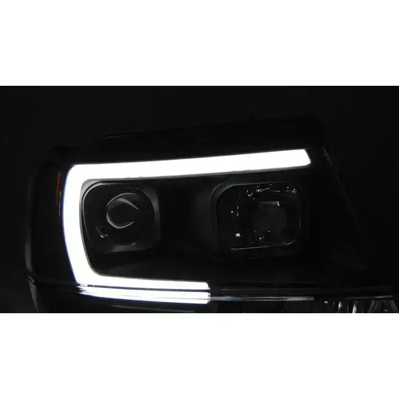 Hovedlys Jeep Grand Cherokee 99-05 Tube Light Black med hvit LED-ramme, lyser i mørket.