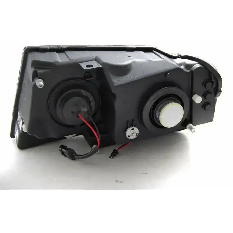 Headlamp for Jeep Grand Cherokee 99-05, bakside med ledninger, pærer og monteringspunkter i svart plast.