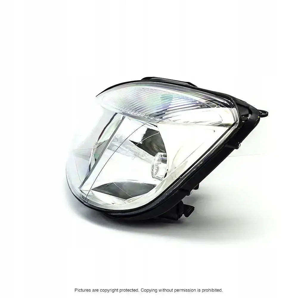 Headlights Kia Rio 05-11 H4 med klart glass, svart plast og synlig reflektor fra skrå vinkel.