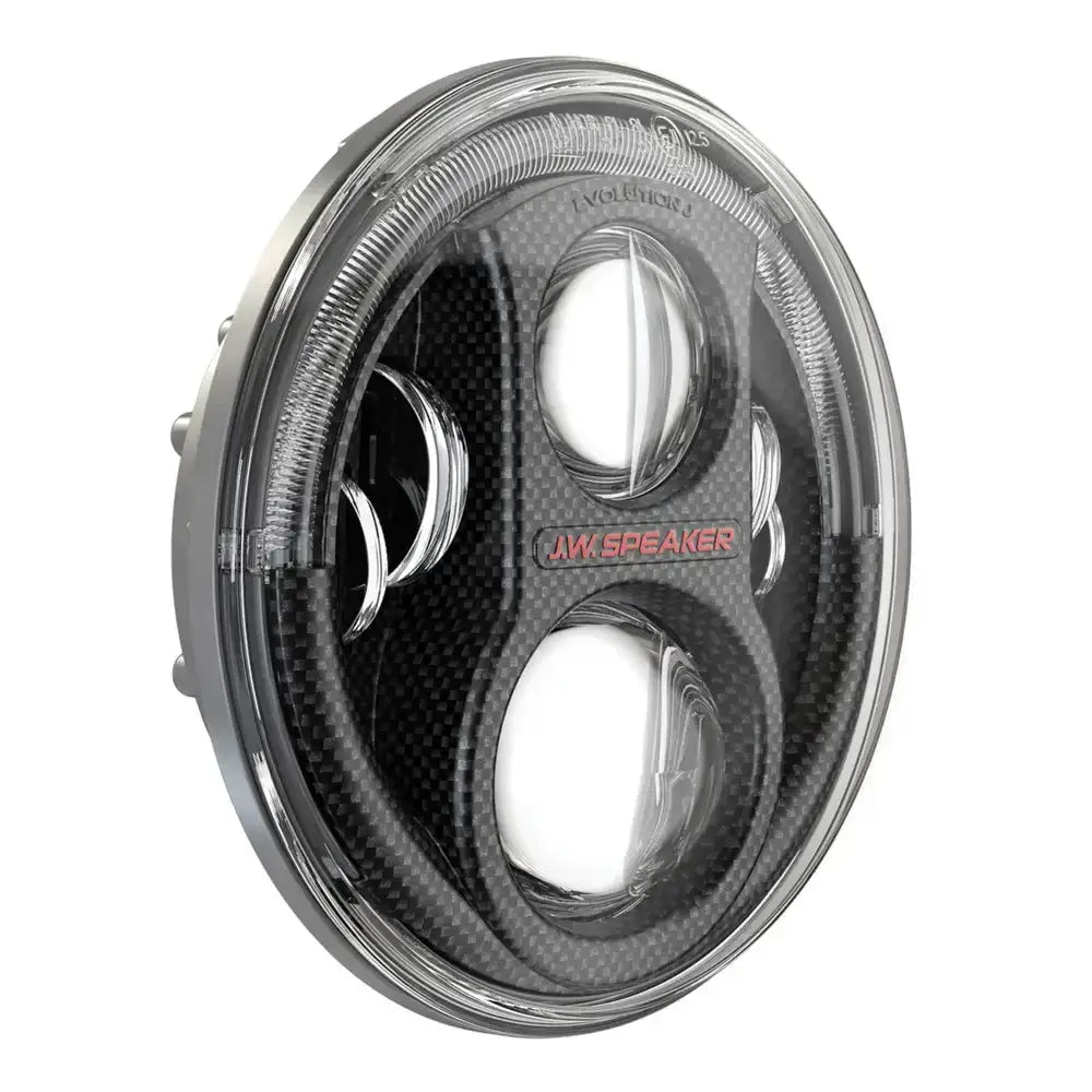 Hovedlykter Led JW Speaker 8700 Evo J2 Carbon med klar linse og karbonfiber-look, sett fra skrå vinkel.