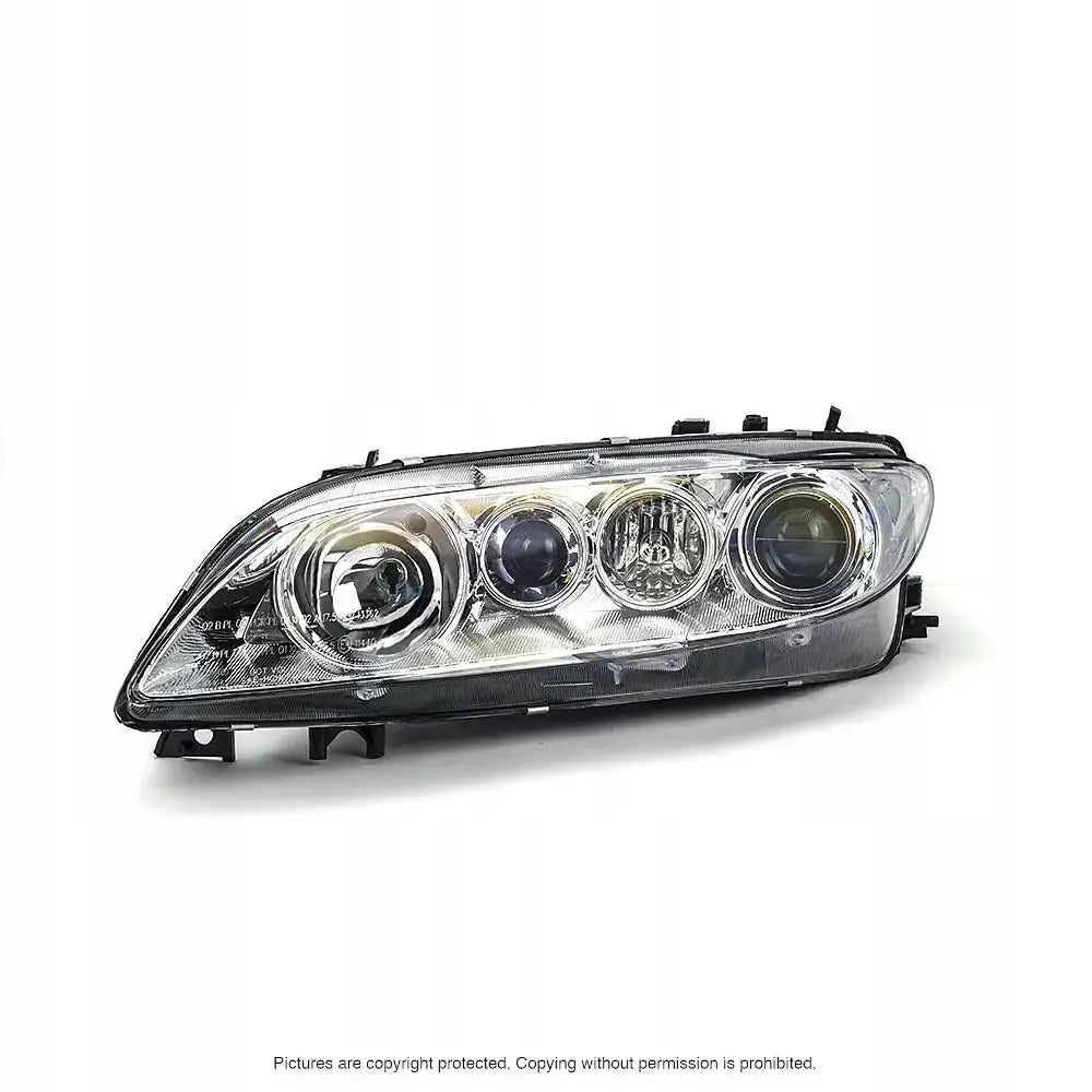 Hovedlykter Mazda 6 02-5 H1/H1/H3 sett forfra med klart glass og sorte detaljer.