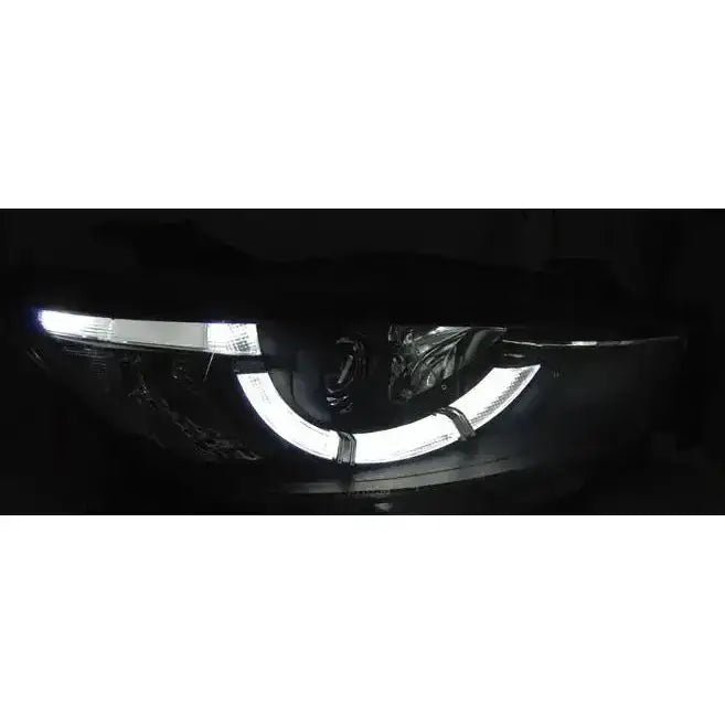 Headlights Mazda CX5 11-15 Black True DRL Xenon med buede hvite LED-lys tent i mørkt miljø.