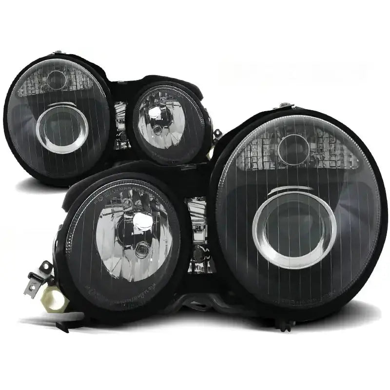 Frontlykter Mercedes W210 E-Klasse 95-05.99 i svart med klare linser og synlige reflektorer.