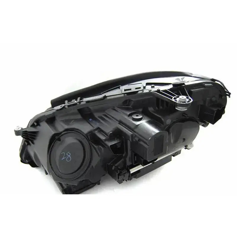 Headlights Mercedes W212 13-16 svart bakside med synlige tekniske komponenter og tallet 28.