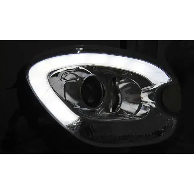 Hovedlys Mini Countryman R60 10-14 med LED-tube, sølv reflektor og blank overflate.