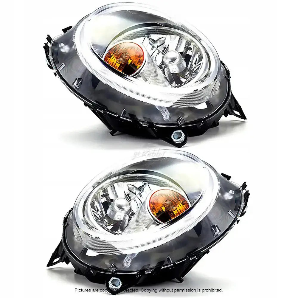 Frontlykter Mini R55 R56 R57 06-15 med klare glass, oransje blinklyspærer og refleksjonselementer.