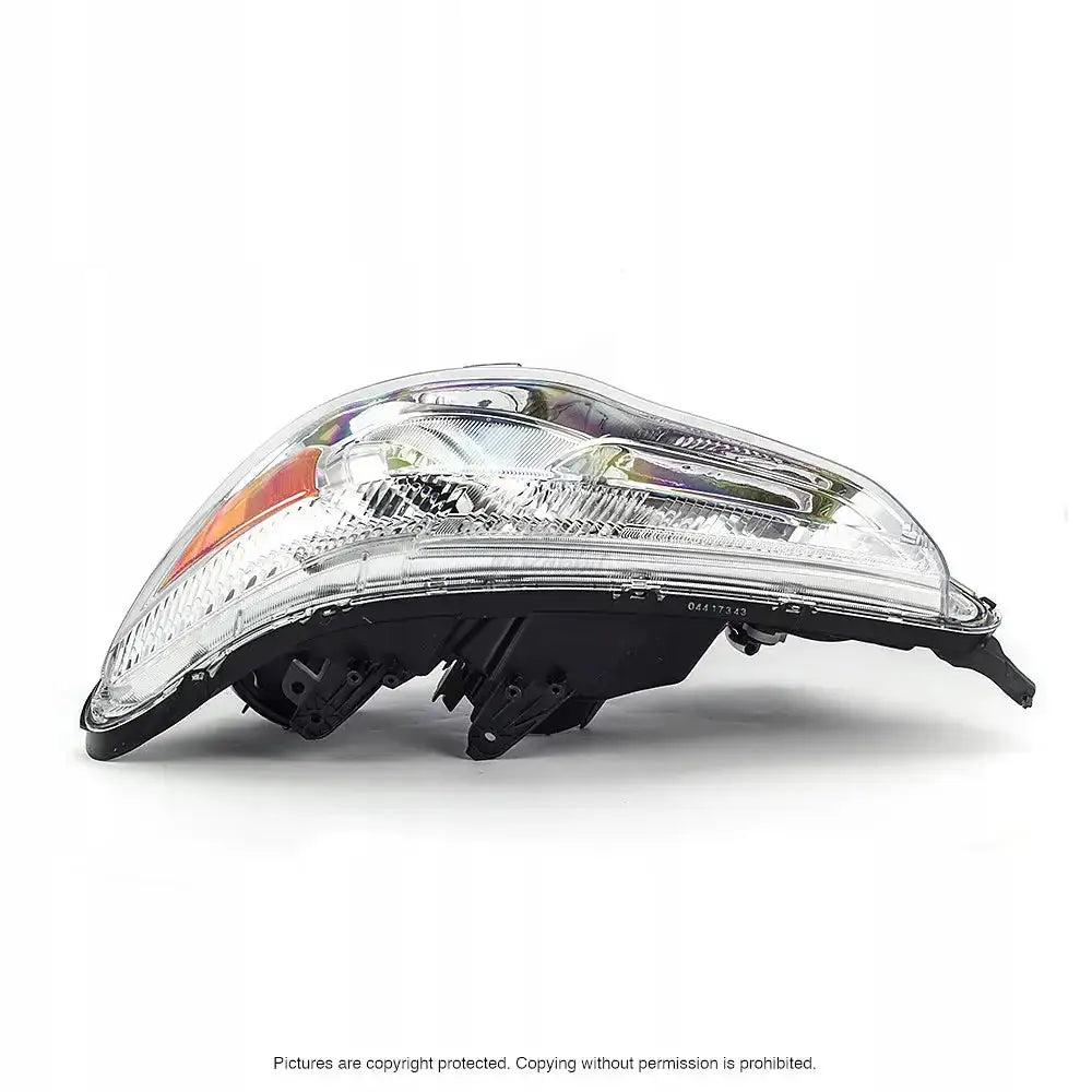 Frontlykter Mitsubishi ASX 10-12 H11 med klart glass, sorte detaljer og oransje reflektor, sett fra siden.